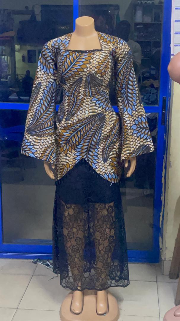 Blue and brown patterned outfit with wide sleeves and a dark lace lower section on a mannequin.