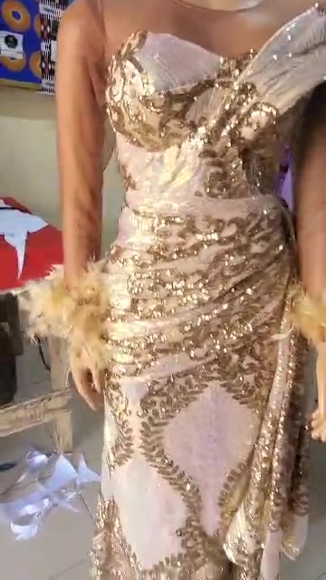 Gold embellished outfit with decorative surface details.