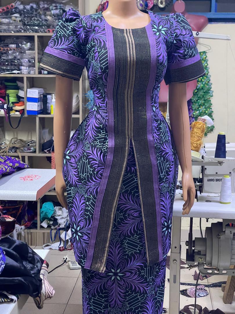 Purple patterned outfit with puff sleeves and a dark front panel on a mannequin.