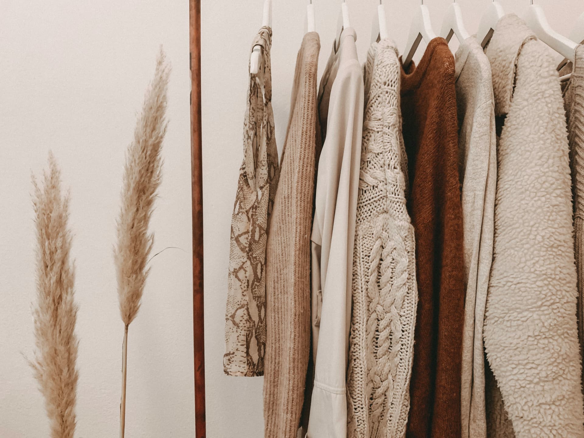 A rail of carefully made garments in warm neutral tones